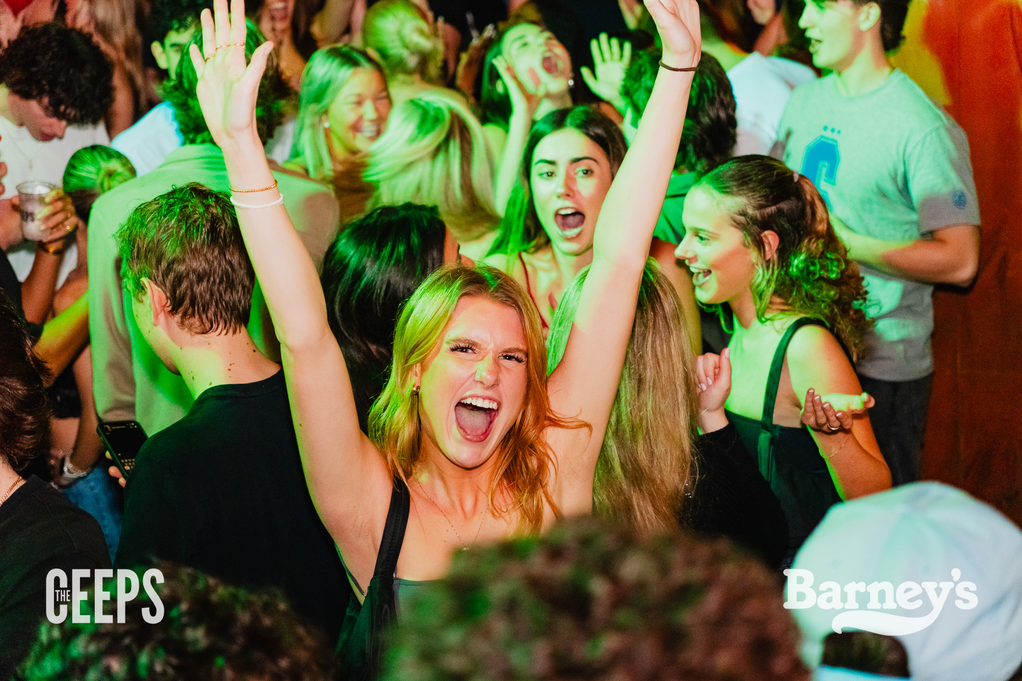 A girl with her hands up with a look of joy on her face